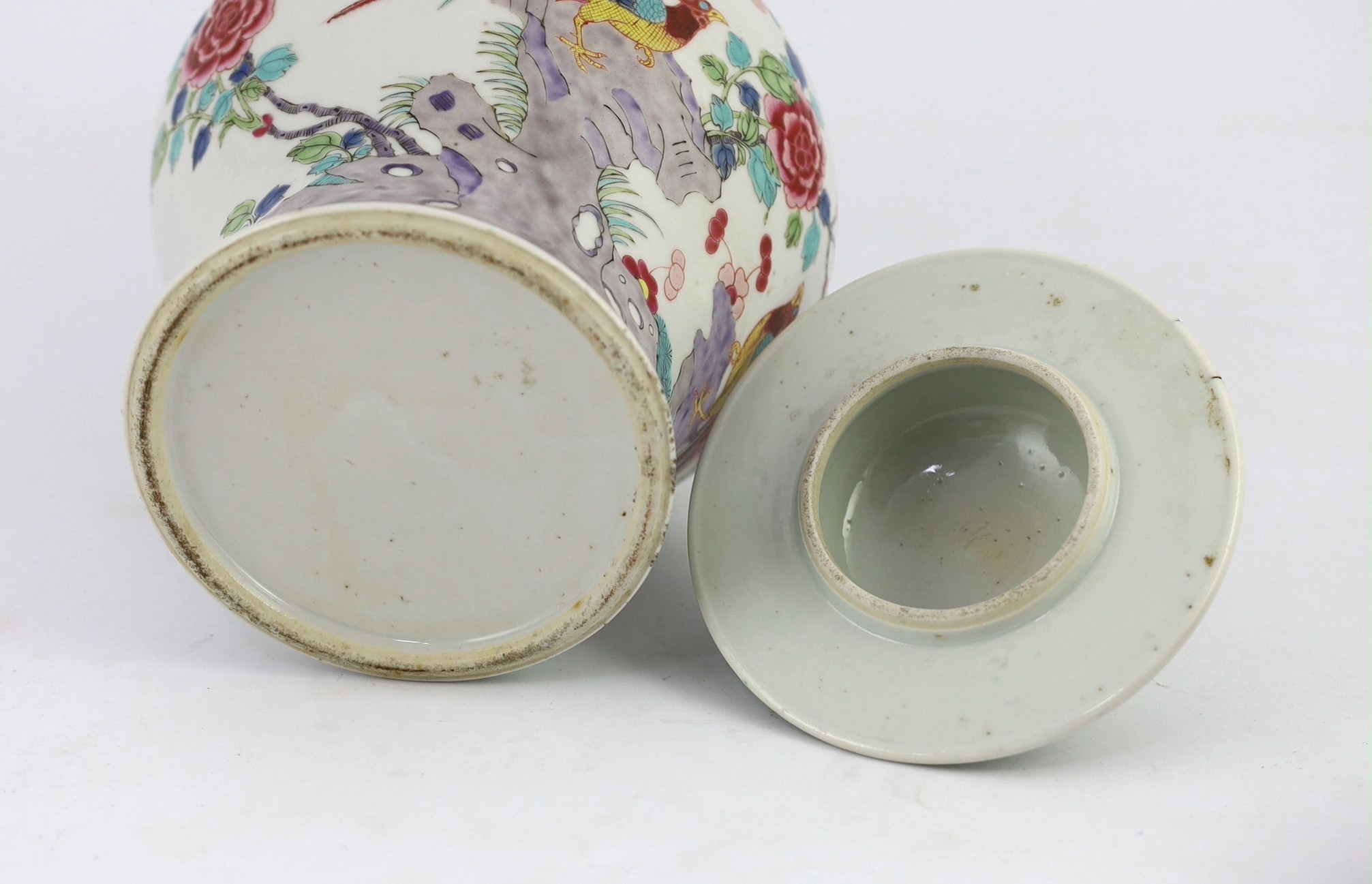 A Chinese famille rose fencai 'pheasant' vase and cover, 19th century, Jiaqing-Daoguang period, 28cm high, small faults to cover, wood stand